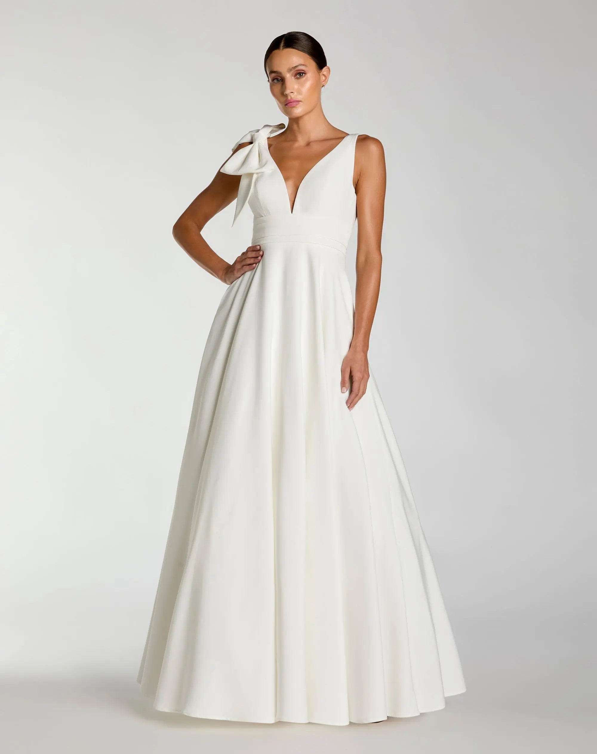 White Sleeveless Plunge Neck Ball Gown With Bow Detail